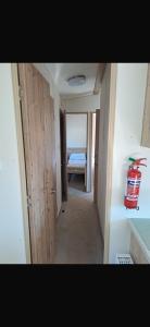 a hallway with a bedroom and a bed in a room at Paradise Holiday home in Lytchett Minster