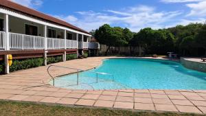 a swimming pool in front of a house at The Dunes Studio 11 in Plettenberg Bay