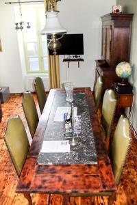 a wooden table with chairs and a dining room at Gîte Le Féodal 3 Etoiles in Tiffauges