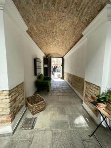 a hallway with a couch and a fireplace in a building at Monferrato Apartments - Ca Marì e Casa Elena in pieno centro storico in Moncalvo