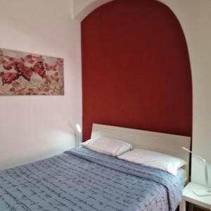 a bedroom with a bed and a painting on the wall at Casa Fortunata con parcheggio in Livorno