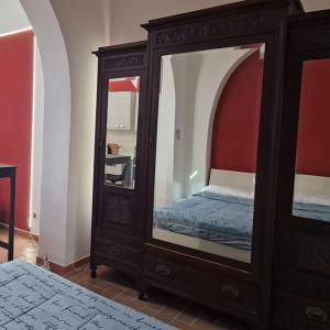 a bedroom with a large mirror and a bed at Casa Fortunata con parcheggio in Livorno