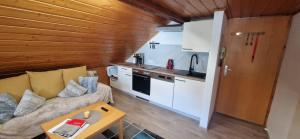 a living room with a couch and a kitchen at Weisshaus Schruns in Schruns-Tschagguns