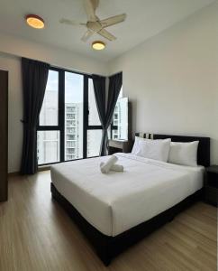 a bedroom with a large white bed with a large window at Jazz Suites Seaview with Bathtub - 2901 in Tanjong Tokong