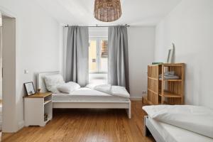 a room with two beds and a window at modern living - BASF - MA - PFALZ - 1 Gym 2 Working Spaces in Ludwigshafen am Rhein