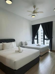 a bedroom with two beds and a ceiling fan at Jazz Suites Seaview with Bathtub - 2901 in Tanjong Tokong