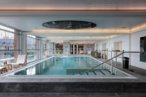 a large swimming pool in a building with a large window at Griffen Spa Hotel in Rønne