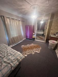 a bedroom with a bed and a room with a mirror at CASA DE MUNCA in Hunslet