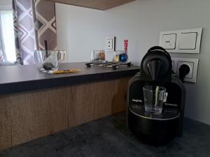 a black blender sitting on a counter in a kitchen at Au 7cent14 in Marcilly-sur-Eure