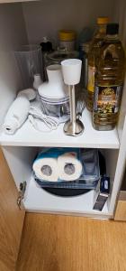 a cupboard with some dishes and other items on it at Apartmanica Residence 511 in Donovaly