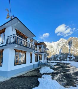 a house in the mountains with snow around it at The Shangbar in Jispa +18 photos