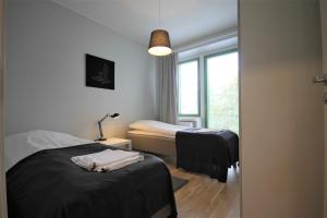 Ένα ή περισσότερα κρεβάτια σε δωμάτιο στο Forenom Serviced Apartments Kuopio