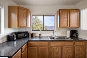a kitchen with a sink and a microwave at Chalet w Stunning Views Hot Tub Fire Pit & WiFi in Old Fields +25 photos