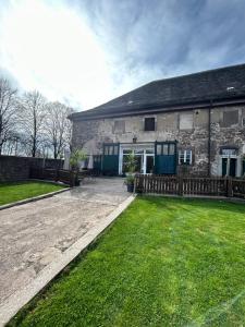 a large stone house with a yard at Weser-Aktivhotel-Corvey in Höxter
