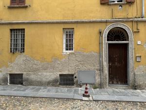 a building with a door and a sign in front of it at moderna ed elegante Residenza nel centro di Pavia in Pavia