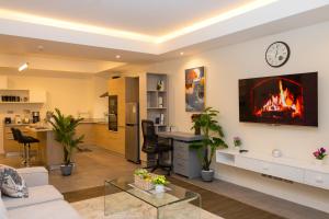 a living room with a fire on the wall at Capital M - Bednbeyond, Westlands Nairobi, Kenya-Call 25472I95O319 in Nairobi