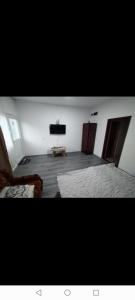 a room with two beds and a flat screen tv at Apartmani Zivkovic Ribarska banja in Ribarska Banja