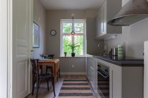 a kitchen with a table and a window at Villa Granliden in Ludvigsborg