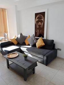 a living room with a couch and a coffee table at Apartamentos El Velero in Torremolinos