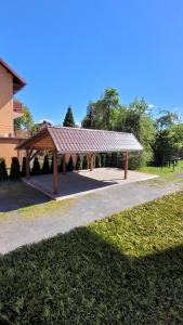 a pavilion with a roof in a park at Apartament Ania in Jelenia Góra