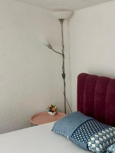 a bedroom with a bed with a lamp and a pillow at Jelly Apartment in Visoko