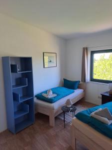 a room with two beds and a window at Großes Familienapartment mitten in der Natur in Neu Gaarz