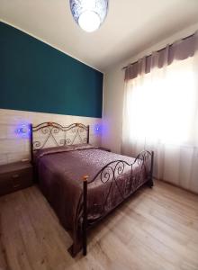 a bedroom with a bed in a room with a window at RoofTop Home Stagnone in Marsala