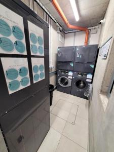 a laundry room with a washer and a washing machine at APARTIA Apartment Brno center in Brno