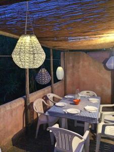 a blue table and chairs on a patio with lights at La casa di Vittorio de Feo in Procida