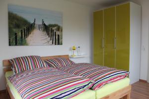 a living room with a couch and a painting of a beach at Haus Schwalbennest in Dassow