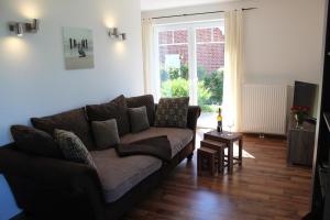 a living room with a couch and a table at Haus Schwalbennest in Dassow