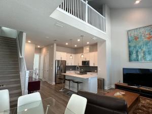 a kitchen and living room with a couch and a table at Luxurious Three-story Townhouse In Payne Park Village in Sarasota