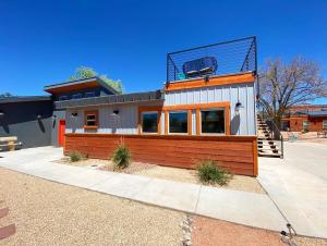 a house with a balcony on top of it at Timber & Tin G 2Bed 2Bath w Pool & Rooftop Deck in Kanab