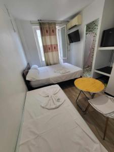 een kleine kamer met een bed en een tafel bij Résidence Richemond in Marseille