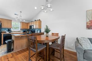 a kitchen with a wooden table and chairs at Heavenly Hideaway Condo in Branson West