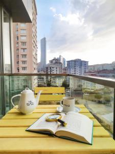 an open book on a table with a view of a city at Ataşehir The Place Suites in Istanbul