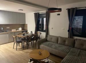 a living room with a couch and a table at Villa Villekulla VV in Kolašin