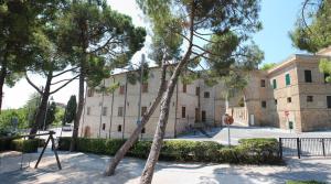 a building with trees in front of it at Dedicato A Te in Montelupone