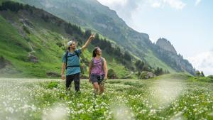 a man and woman standing in a field of flowers at Résidence Manaka in Aime La Plagne