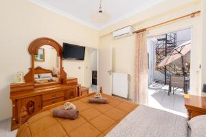 a bedroom with a large bed with a large mirror at Analiti Civita - Mando in Patra