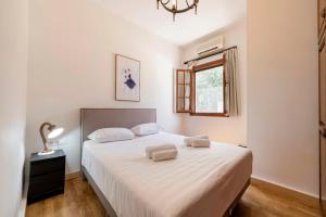 A bed or beds in a room at Ariadni Villas Faliraki