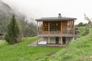 a wooden house on top of a hill at Chalet Olbios in Peisey-Nancroix