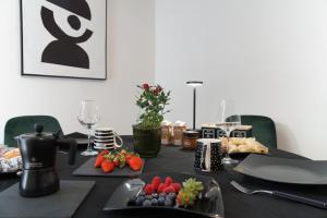a black table with food and fruit on it at RUDIAE Palace In Lecce in Lecce