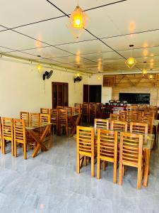 a dining room with wooden tables and chairs at Muthanga Wild Resort in Muthanga