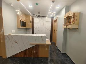 a kitchen with a marble counter top and a hallway at HOTEL NEW YORK in Ahmedabad