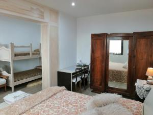 a bedroom with a desk and a bed with a mirror at Ca' Pietra di Nonno Pietro in Gavardo