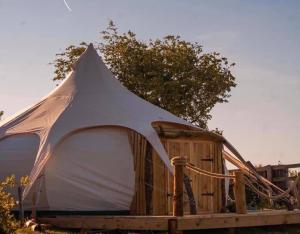 a large tent sitting on a wooden platform at Bella in Abergele