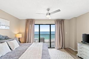 a bedroom with a bed and a view of the ocean at Commodore Resort #704 by Book That Condo in Panama City Beach +93 photos
