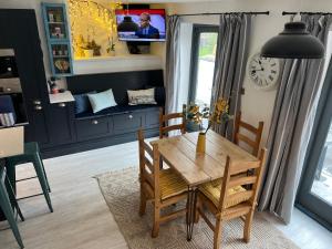 a dining room with a wooden table and chairs at The End House at The Old Farmhouse in Cowbridge
