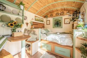 a bedroom in a tiny house at Spinney Retreats - 2 x Unique Shepherds Huts Dog Friendly in Northampton
